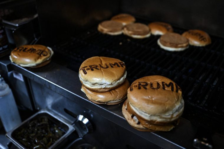 US President Donald Trump's last name is stamped on buns, at the Trump Burger restaurant in Bellville, Texas, on April 19, 2025. It is lunchtime at a Texas eatery called Trump Burger and diners are enjoying fast food and the frenetic first 100 days of their president's second term. Trump is everywhere in this joint with a dozen tables -- in cardboard cutouts of the man eking out his trademark forced smile, on banners from the 2024 campaign, and on hats and T-shirts displayed for sale. It is a franchise of a company with four such Trump-themed outlets in Texas and no equal anywhere else in America. The chain is not linked to the Trump Organization. (Photo by RONALDO SCHEMIDT / AFP) (Photo by RONALDO SCHEMIDT/AFP via Getty Images)