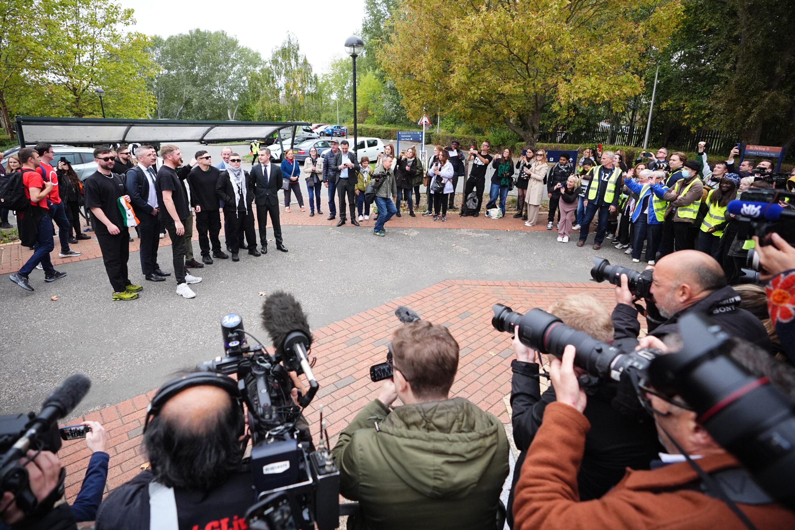 Kneecap’s Liam Og O hAnnaidh (second right, in keffiyeh), with (second left to right) band manager Daniel Lambert, JJ O’Dochartaigh, Naoise O Caireallain and lawyer Darragh Mackin, posing for a photo outside Woolwich Crown Court, London (James Manning/PA)