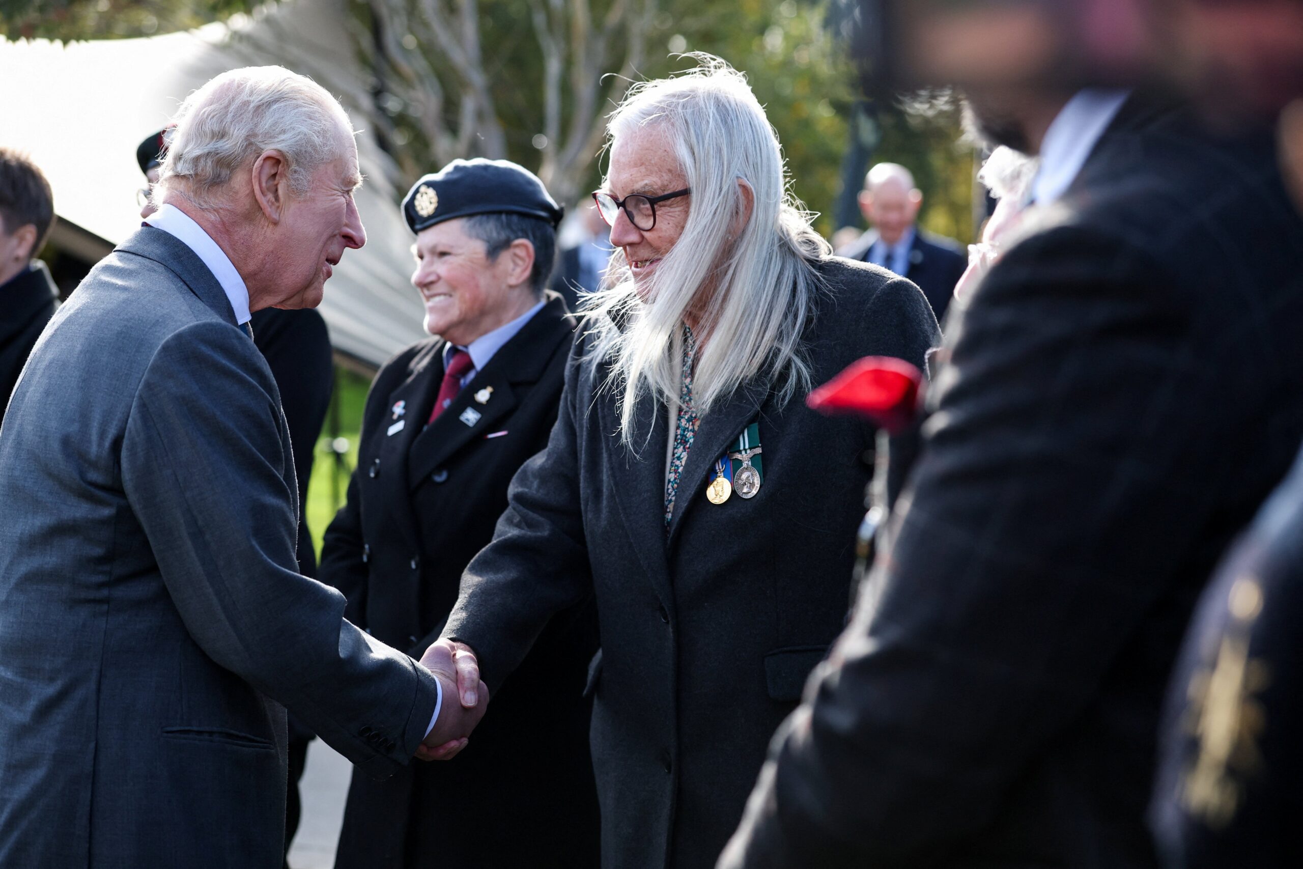 The King greets a veteran during the dedication ceremony