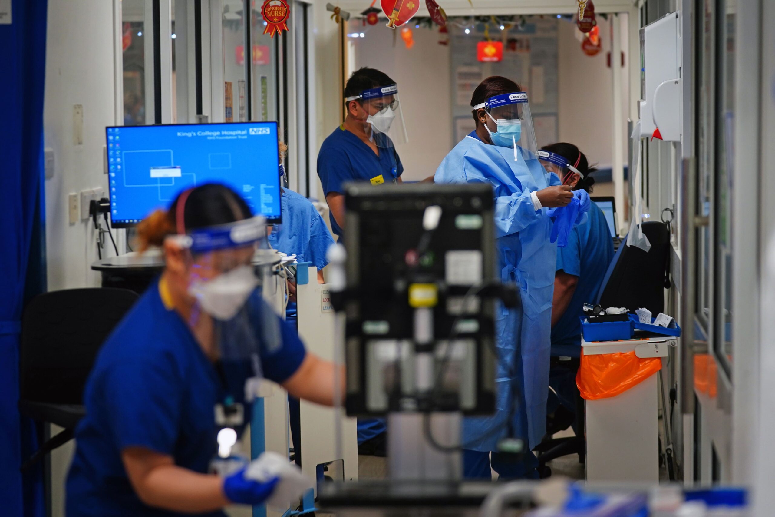 NHS staff wearing PPE help Covid patients