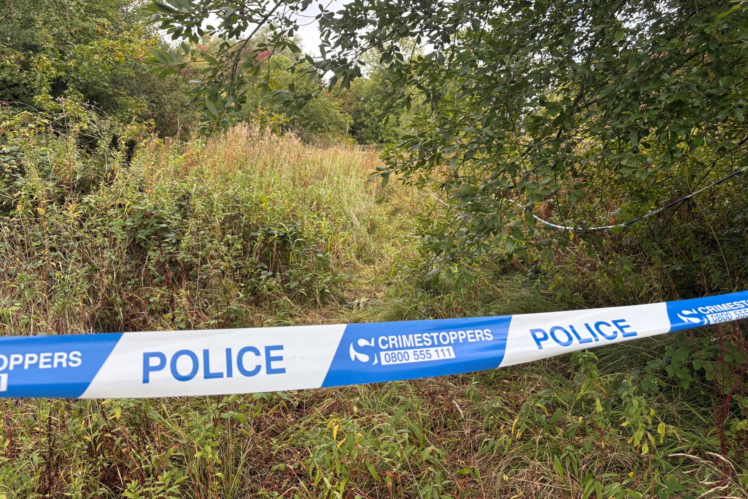 A police cordon is seen in the grassland off Tame Road, Oldbury (Matthew Cooper/PA)