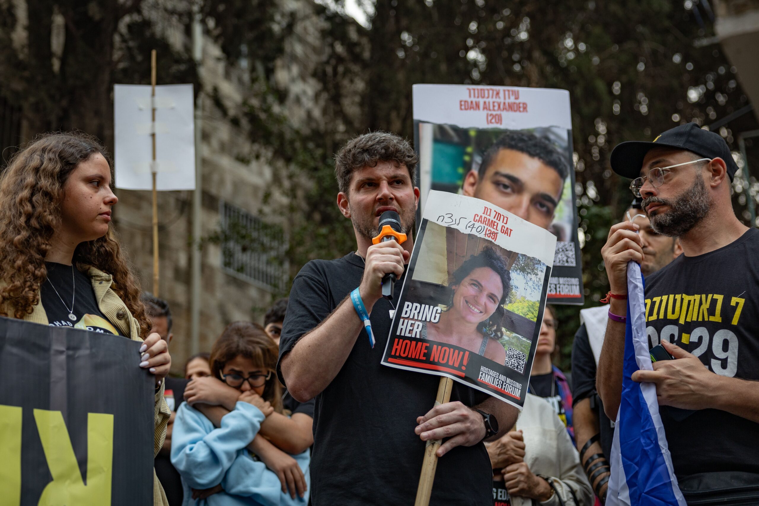 Gil Dickmann, centre, the cousin of killed hostage Carmel Gat, directly addressing Benjamin Netanyahu at a rally