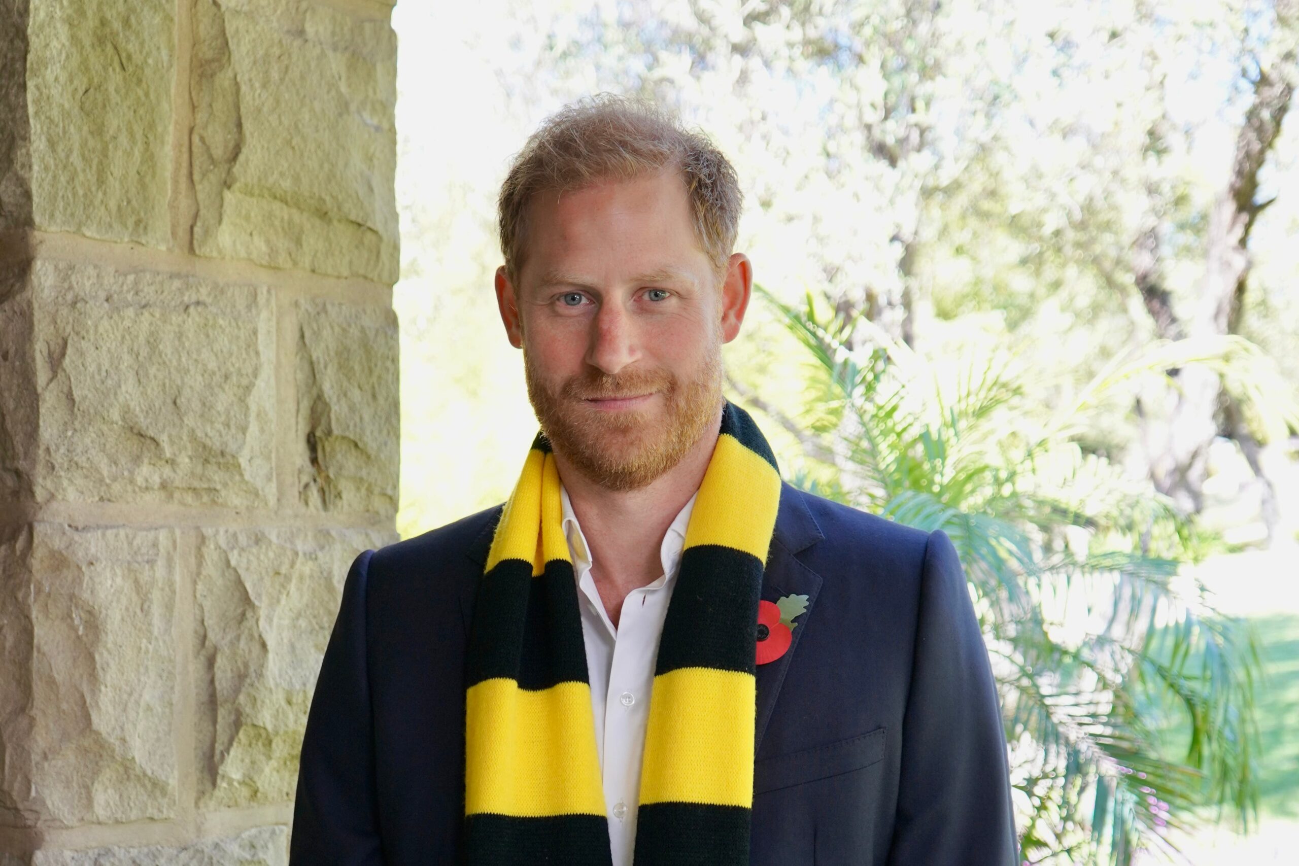 Harry wearing one of Scotty’s Little Soldiers scarves and a poppy (Archewell/PA)