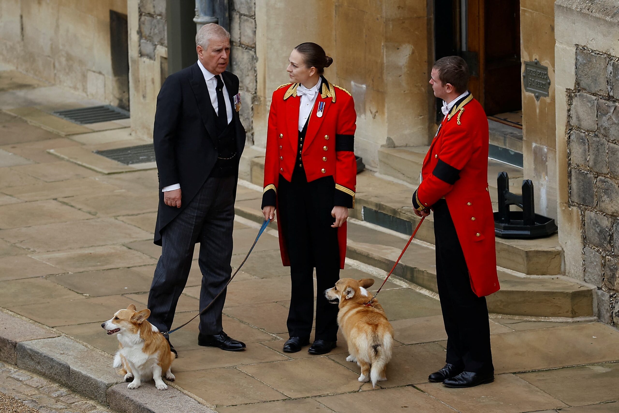 Andrew with members of the royal household as they hold the late Queen’s corgis, Muick and Sandy, ahead of her committal service at St George’s Chapel in 2022 (Peter Nicholls/PA)