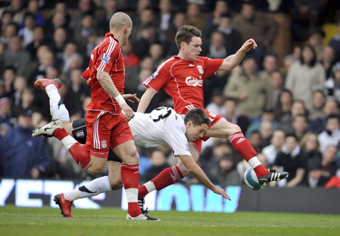 Liverpool's Steve Finnan steers the ball away vs Fulham’s Clint Dempsey