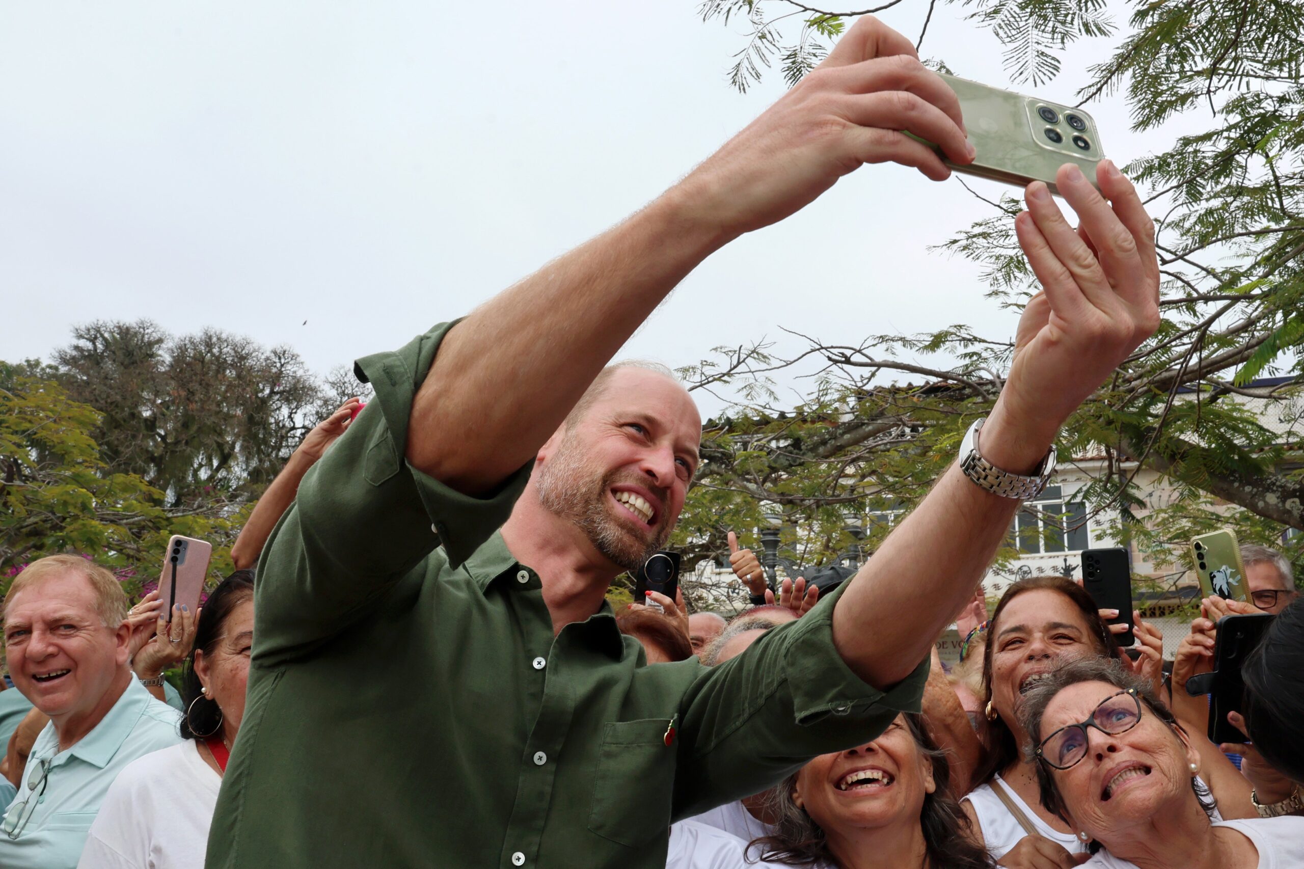 Prince William takes selfies with the crowd on the second day of his tour to Brazil
