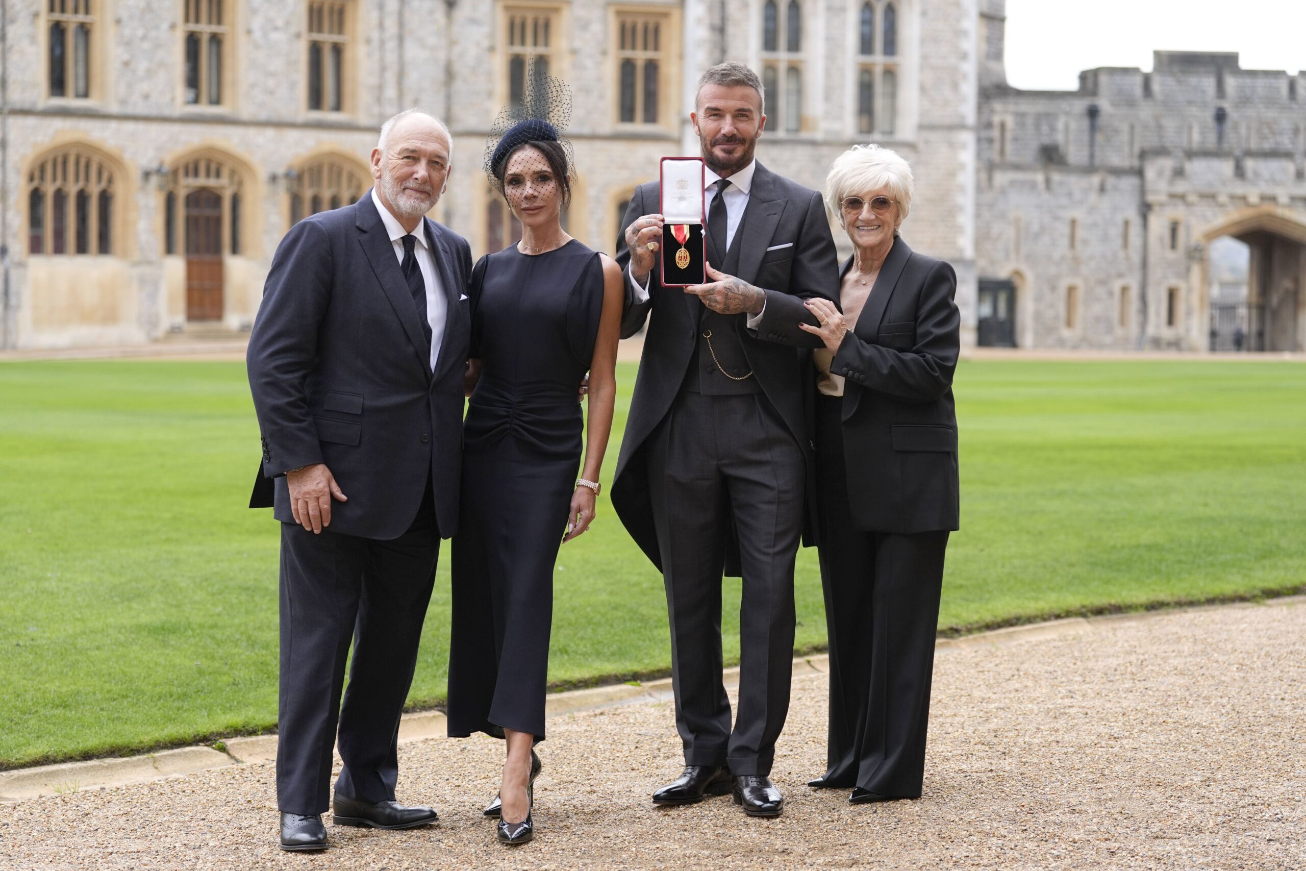Sir David Beckham, with his wife Lady Victoria and parents Ted and Sandra Beckham, after he was made a Knight Bachelor at an investiture ceremony at Windsor Castle, Berkshire