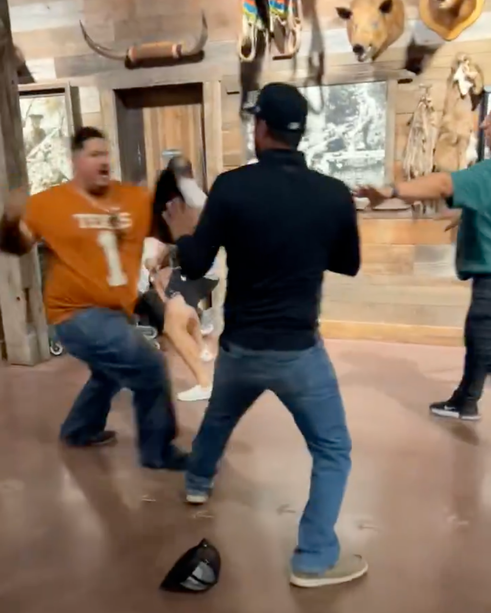 At one point, a man wearing a Texas Longhorns jersey jumped into the fray, shoving and swinging at another man