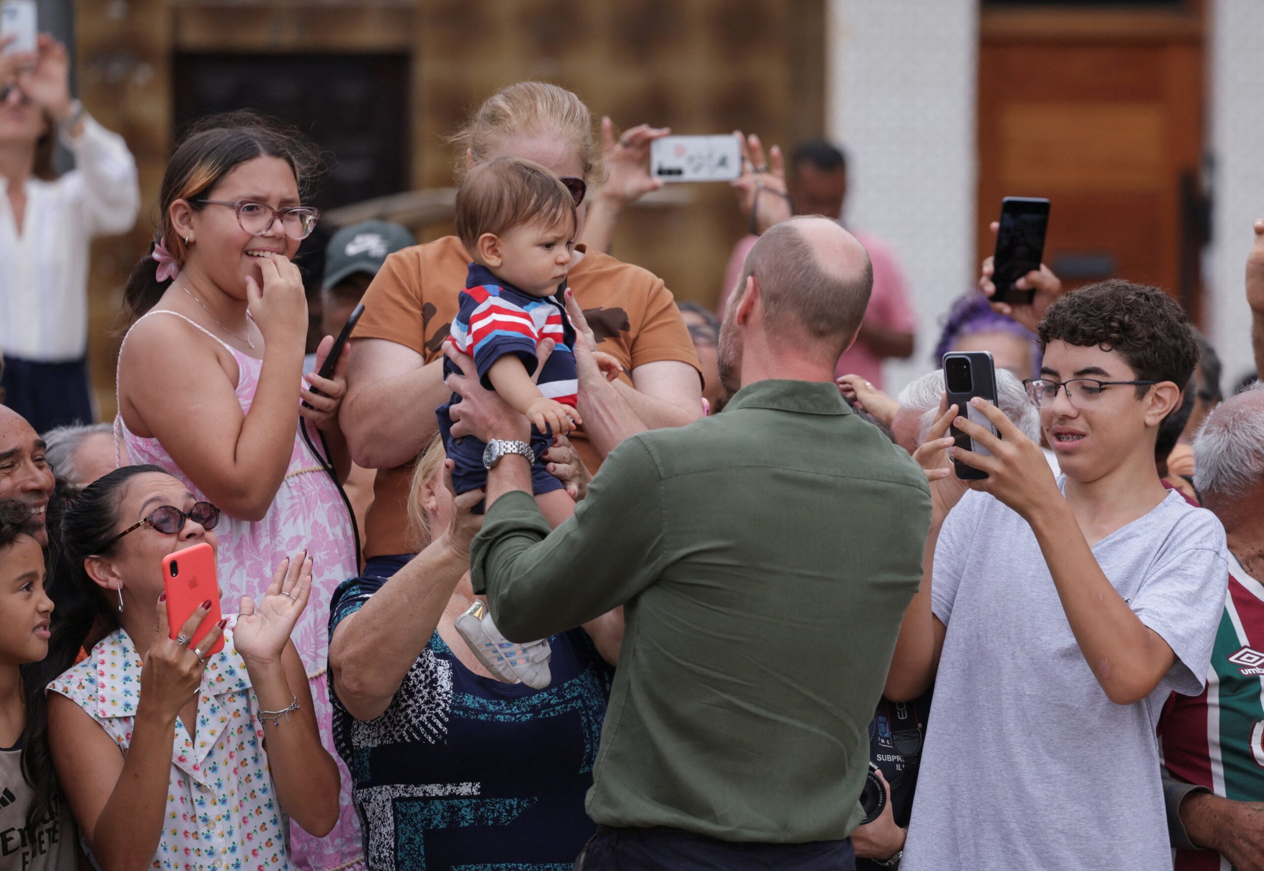 Britain's Prince William greets people on Paqueta island, during an official visit in Rio de Janeiro, Brazil