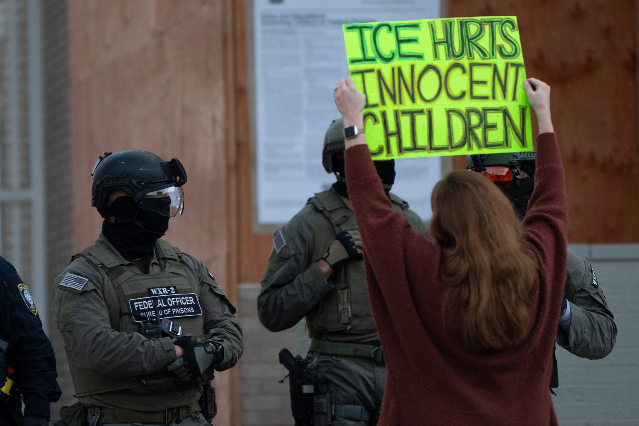 A woman protests Department of Homeland Security agents with a sign that reads “ICE hurts innocent children.” ICE agents in Rhode Island detained a 16-year-old intern at the Rhode Island Superior Court on November 20, 2025. The intern was released after his identify was verified by ICE (file image)