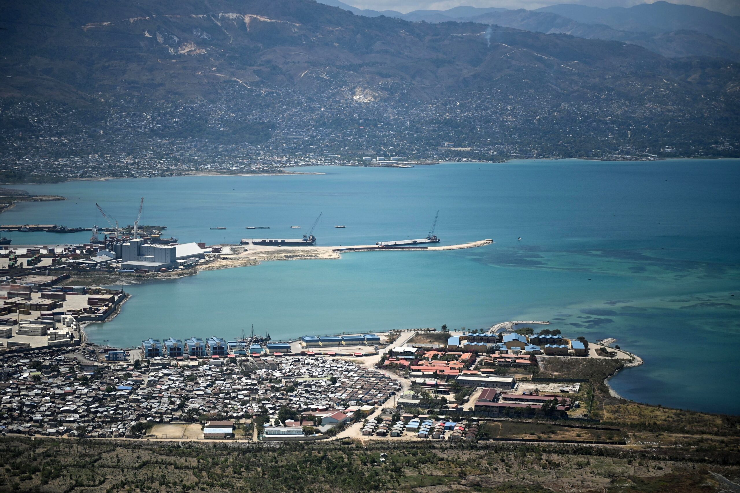 The two men looked to take over a small island that is part of Haiti, prosecutors said.