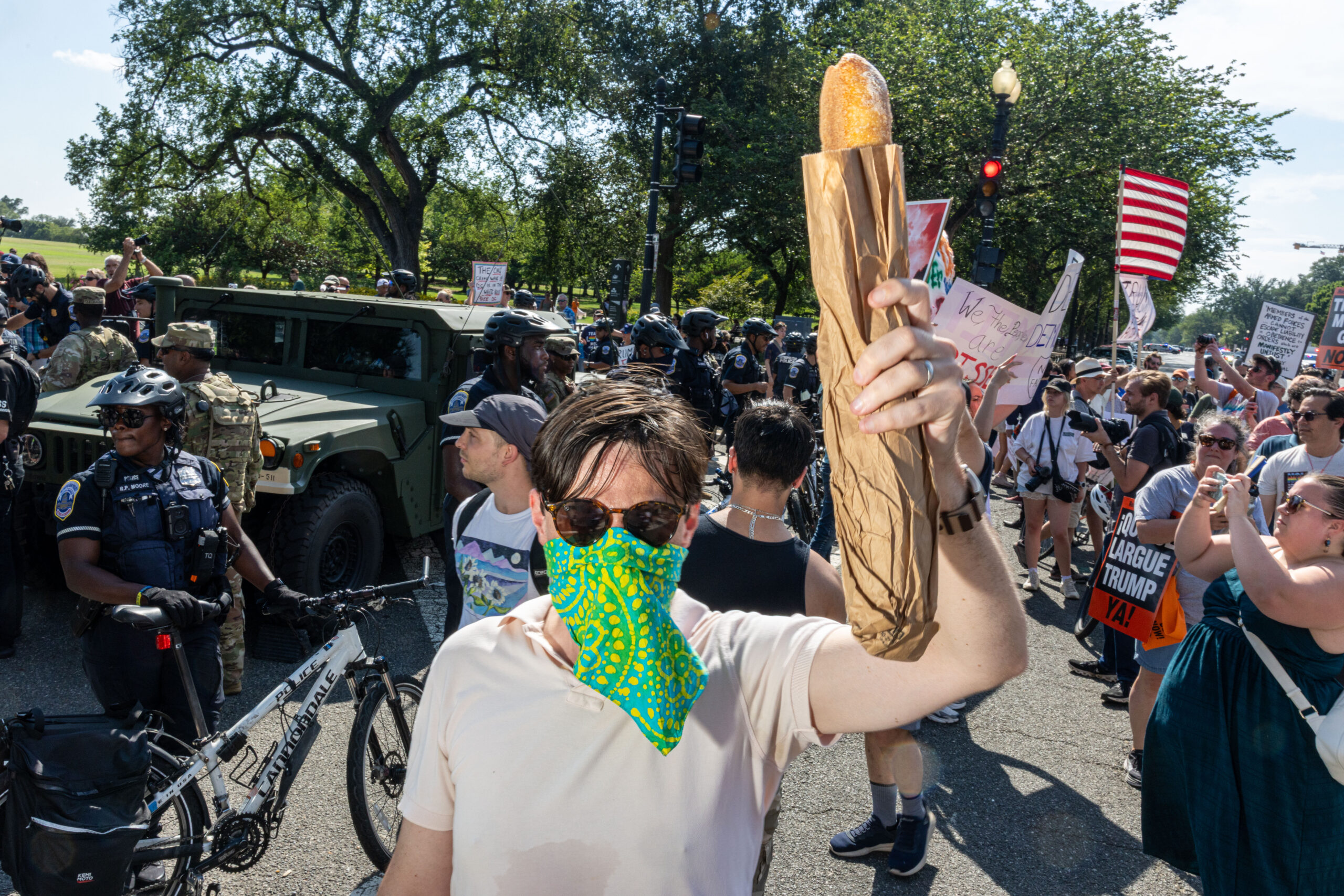 A demonstrator holds a piece of bread as he protests against the increased federal law enforcement presence in Washington, D.C. on Saturday.