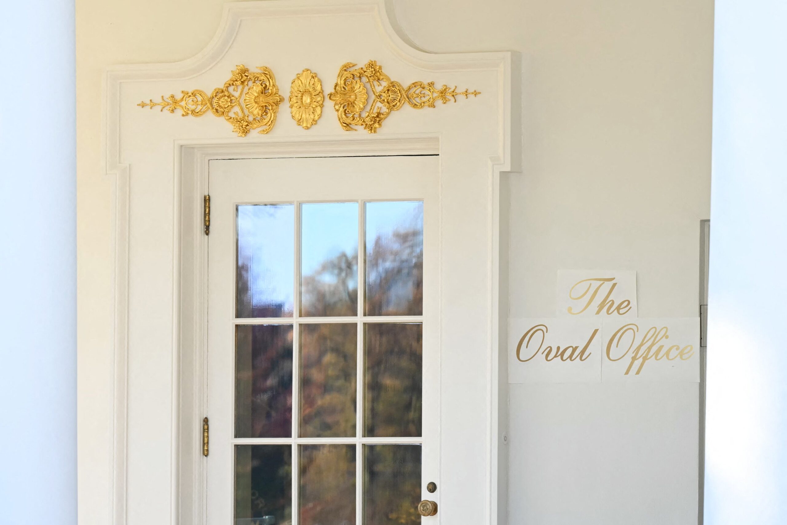 The new sign at the Oval Office appears to be taped directly onto the White House walls