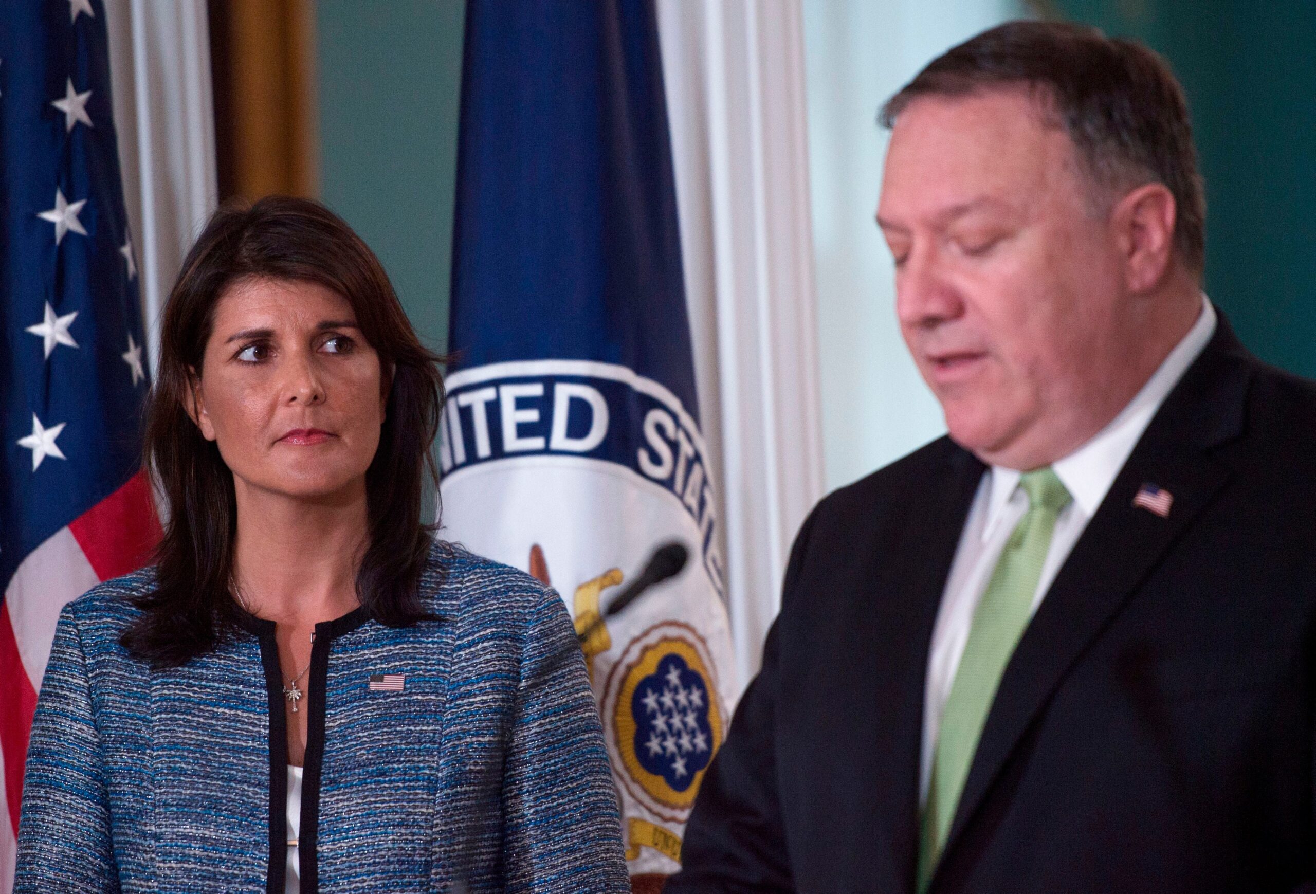 Former US Secretary of State Mike Pompeo, right, speaks as US Ambassador to the United Nation Nikki Haley looks on at the US Department of State in Washington DC on June 19, 2018