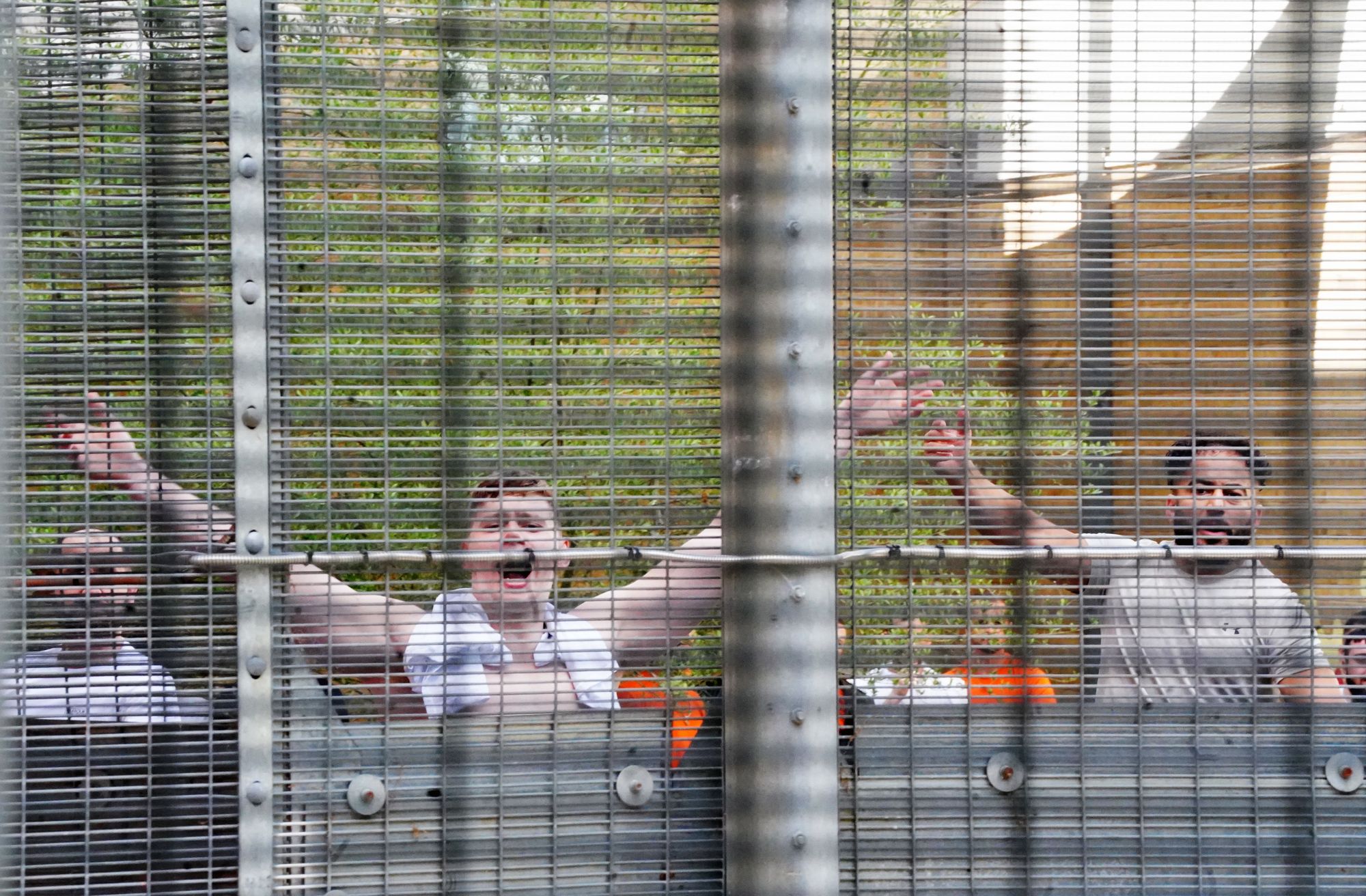 People held at Brook House Immigration Removal Centre at Gatwick respond to demonstrators from migrants rights groups protesting against plans to send migrants to Rwanda in June 2022. Brook House was subject to an inquiry after a 2017 Panorama investigation uncovered abuse by immigration staff.