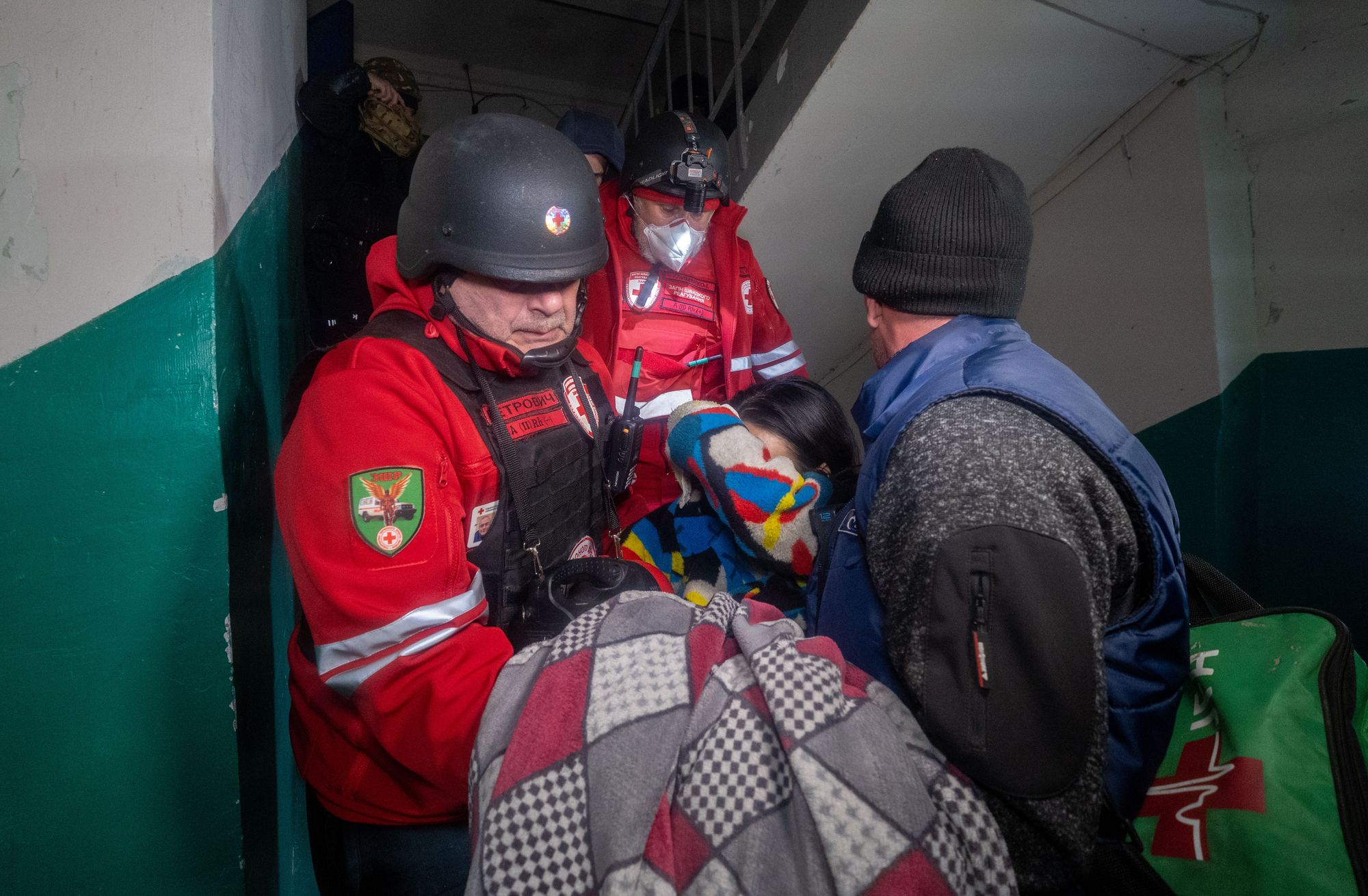 Rescuers evacuate an injured civilian after a residential building was hit following Russia's missile attack in Kharkiv