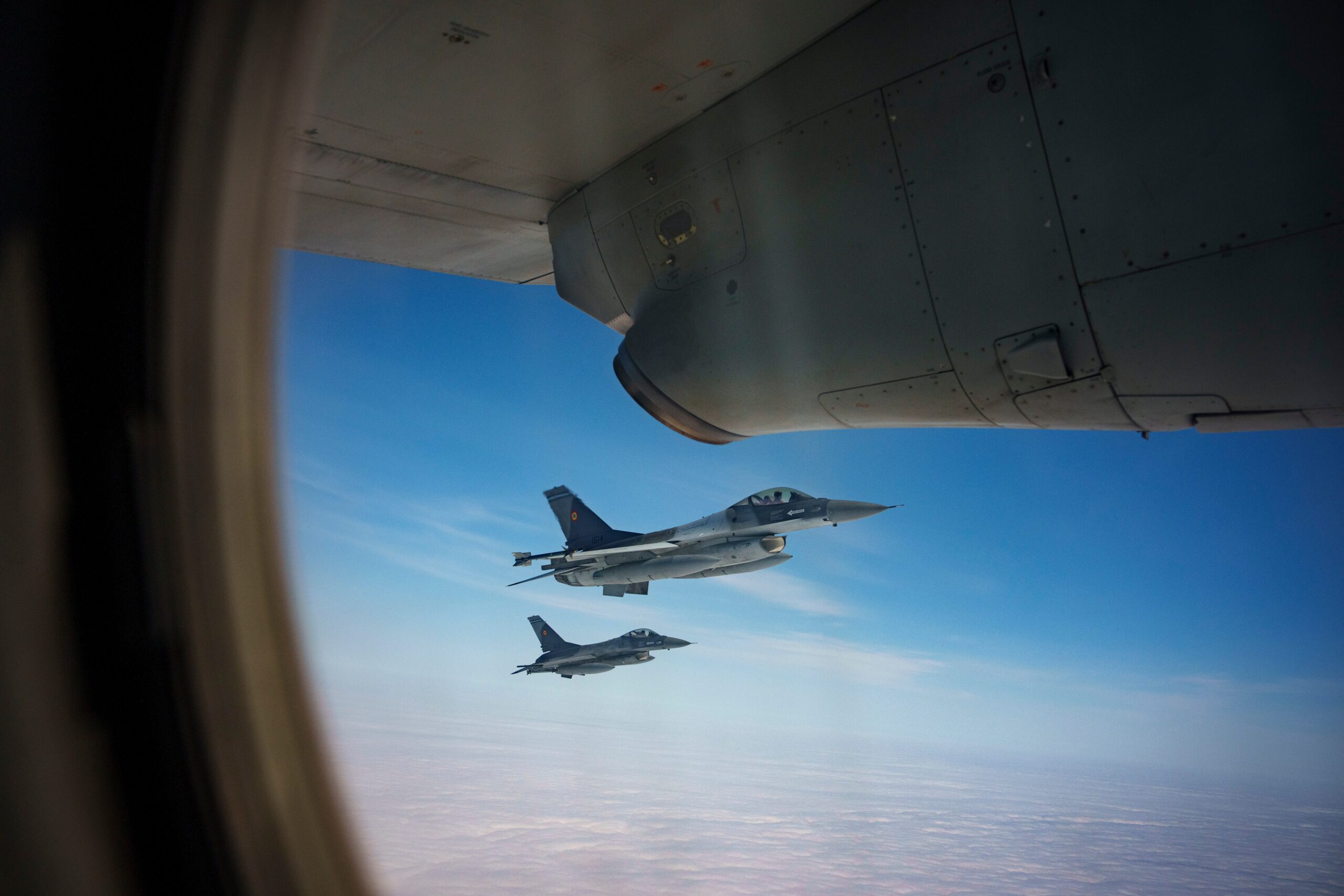 File: Romanian Air Force F-16 military fighter jets escort a C-27J Spartan aircraft during a Nato air policing exercise above eastern Romania