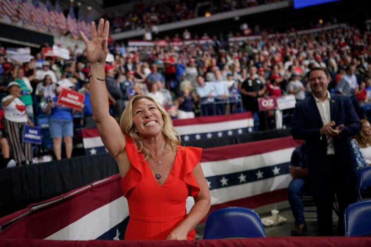 FILE - Rep. Marjorie Taylor Greene, R-Ga., waves at supporters before former President Donald Trump speaks at a rally in Wilkes-Barre, Pa., Sept. 3, 2022. Once shunned as a political pariah for her extremist rhetoric, the Georgia lawmaker who spent her first term in Congress stripped of institutional power by Democrats is being celebrated by Republicans and welcomed into the GOP fold. (AP Photo/Mary Altaffer, File)