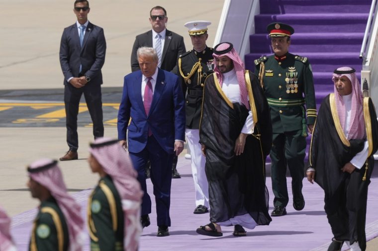 President Donald Trump walks with Saudi Crown Prince Mohammed bin Salman during an arrival ceremony at the Royal Terminal of King Khalid International Airport in Riyadh, Saudi Arabia, Tuesday, May 13, 2025
