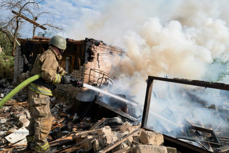 IVERSKE, UKRAINE - AUGUST 26: A firefighter extinguishes a burning house following a random Russian Shahed drone strike on a house near the frontline on August 26, 2025, in Iverske, Ukraine. The village is located north of Pokrovsk in the Donetsk Oblast. Recently, Russian President Vladimir Putin proposed that Ukraine cede unoccupied parts of Donetsk Oblast in exchange for freezing the front line, a proposal rejected by Ukrainian President Volodymyr Zelenskyy. (Photo by Pierre Crom/Getty Images)