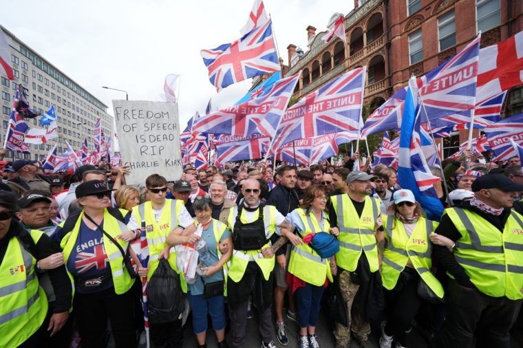 A person holds a banner reading 'RIP Charlie Kirk' during the Tommy Robinson-led Unite the Kingdom march and rally in central London. Picture date: Saturday September 13, 2025. PA Photo. The Tommy Robinson-led Unite the Kingdom march and rally, and the March Against Fascism, organised by Stand Up To Racism (SUTR), are both taking place in the city. Photo credit should read: Lucy North/PA Wire