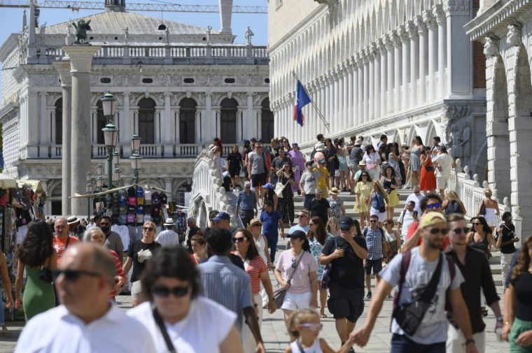 Tourists walk past the Bridge of Sighs with St. Mark's Square in the background in San Marco sestiere in Venice, Italy, on August 25, 2025. (Photo by Aleksander Kalka/NurPhoto via Getty Images)