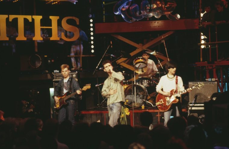 The Smiths (left to right: Andy Rourke, Morrissey, Mike Joyce, and Johnny Marr) on stage in 1984 (Photo: Pete Cronin/ Redferns/ Getty)