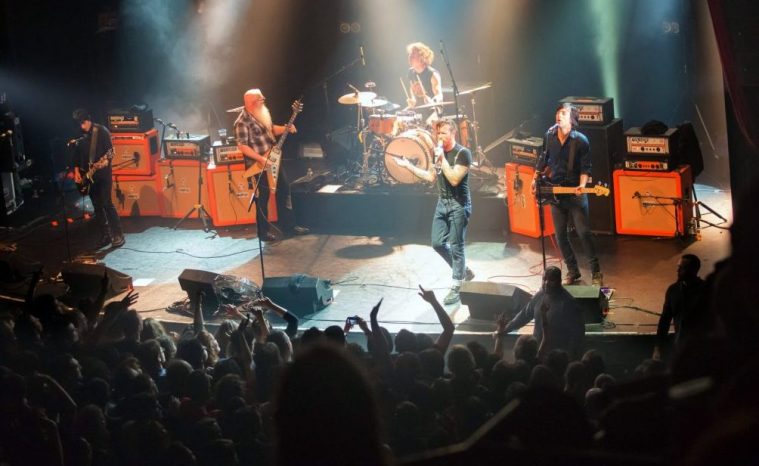 (FILES) American rock group Eagles of Death Metal perform on stage on November 13, 2015 at the Bataclan concert hall in Paris, few moments before four men armed with assault rifles stormed into the venue. November 15, 2025 will mark the tenth anniversary of the November 13 attacks, a series of gun attacks that occurred across Paris and outside the national stadium (Stade de France) in Saint-Denis, North of Paris, on November 13, 2015. (Photo by Marion Ruszniewski / ROCK&FOLK / AFP) (Photo by MARION RUSZNIEWSKI/ROCK&FOLK/AFP via Getty Images)