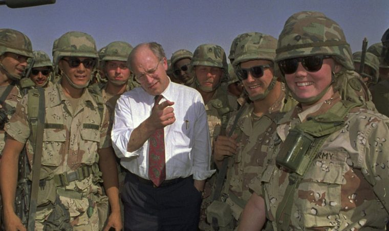 FILE - Defense Secretary Dick Cheney poses with some of the U.S. Army troops stationed in southern Iraq in this May 7, 1991 file photo. (AP Photo/Bill Haber, File)