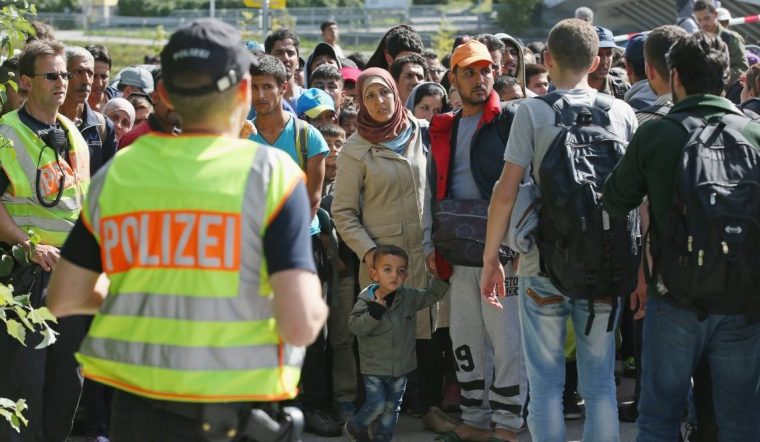 FREILASSING, GERMANY - SEPTEMBER 16: German policemen watches over migrants who had arrived on foot from the Salzburg train station in Austria to the border to Germany on September 16, 2015 at Freilassing, Germany. Hundreds of migrants who had been stuck in Salzburg and unable to find available seats on trains going to Germany broke off in groups to reach the nearby border to Germany on foot. German authorities have temporarily reinstated border controls along Germany's border to Austria and are conducting spot checks on arriving traffic. Germany is still accepting up to thousands of new migrants daily but has imposed border controls in order to crack down on smugglers and to better regulate the flow of arriving migrants, tens of thousands of whom arrived in Germany over the last few weeks. Meanwhile Hungary has sealed it new fence along its border to Serbia and migrants are now heading to Croatia in an effort to reach western Europe.. (Photo by Sean Gallup/Getty Images)