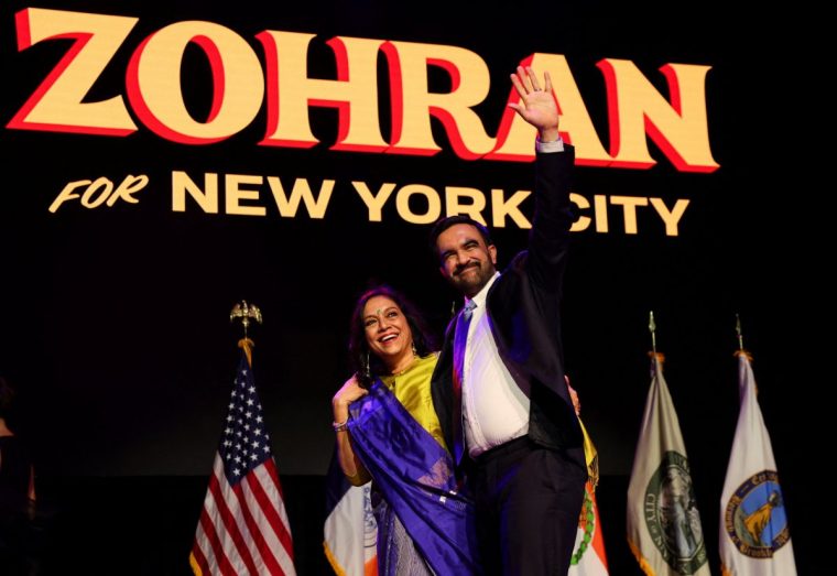 Democratic candidate for New York City mayor Zohran Mamdani waves next to his mother Mira Nair onstage after winning the 2025 New York City Mayoral race, at an election night rally in the Brooklyn borough of New York City, New York, U.S., November 4, 2025. REUTERS/Shannon Stapleton