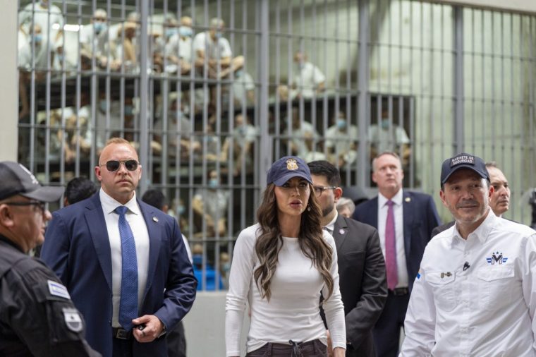 TECOLUCA, EL SALVADOR - MARCH 26: Minister of Justice and Public Security H??ctor Villatoro, (R), accompanies Department of Homeland Security Secretary Kristi Noem, (C), during a tour of the Terrorist Confinement Center (CECOT) on March 26, 2025 in Tecoluca, El Salvador. The Trump administration deported 238 alleged members of the Venezuelan criminal organizations 'Tren De Aragua' and Mara Salvatrucha with only 23 being members of the Mara. Nayib Bukele president of El Salvador announced that his government will receive the alleged members of the gang to be taken to CECOT.??(Photo by Alex Brandon-Pool/Getty Images)