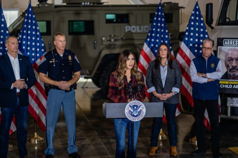 GARY, INDIANA - OCTOBER 30: U.S. Homeland Security Secretary Kristi Noem (C) speaks alongside (L-R) Acting Immigration and Customs Enforcement Director Todd Lyons, Indiana Secretary of Public Safety Anthony Scott, ICE Deputy Director Madison Sheahan and Indiana Gov. Mike Braun during a press conference about ongoing immigration enforcement efforts under Operation Midway Blitz, a federal initiative by President Donald Trump's administration, on October 30, 2025, in Gary, Indiana. Noem discussed new limits on commercial driver's licenses for non-citizens as part of the broader Operation Midway Blitz enforcement effort across the Chicago region. (Photo by Jamie Kelter Davis/Getty Images)