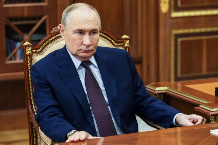 Russian President Vladimir Putin, listens to Chief Justice of Russia Igor Krasnov, not pictured, during their meeting at the Kremlin in Moscow, Wednesday, Nov. 5, 2025. (Gavriil Grigorov, Sputnik, Kremlin Pool Photo via AP)