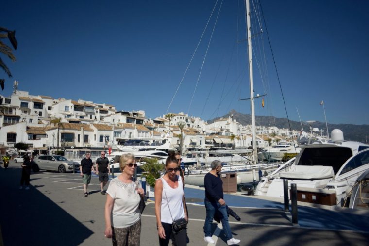 People stroll in Puerto Banus luxury marina and shopping complex in Marbella on March 2, 2022. - Marbella is one of the favorite destinations for Russian tourists and residents in Spain. (Photo by JORGE GUERRERO / AFP) (Photo by JORGE GUERRERO/AFP via Getty Images)