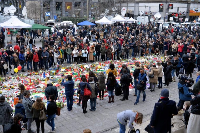 BRUSSELS, BELGIUM - MARCH 24: People gather at Place de la Bourse (Brussels Stock Exchange Square) to commemorate multiple terrorist attack victims in Brussels, Belgium on March 24, 2016. Brussels terrorist bombings in both Zaventem airport and Maelbeek metro station killed 31 people and injured 260 others. (Photo by Dursun Aydemir/Anadolu Agency/Getty Images)