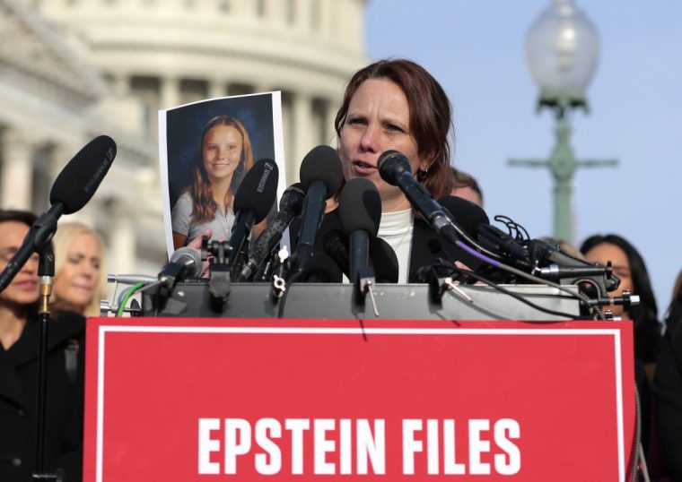 WASHINGTON, DC - NOVEMBER 18: Epstein abuse survivor Jena-Lisa Jones holds up a photo of her younger self during a news conference with lawmakers on the Epstein Files Transparency Act outside the U.S. Capitol on November 18, 2025 in Washington, DC. The House is expected to vote today on the legislation, which instructs the U.S. Department of Justice to release all files related to the late accused sex trafficker Jeffrey Epstein. (Photo by Heather Diehl/Getty Images)