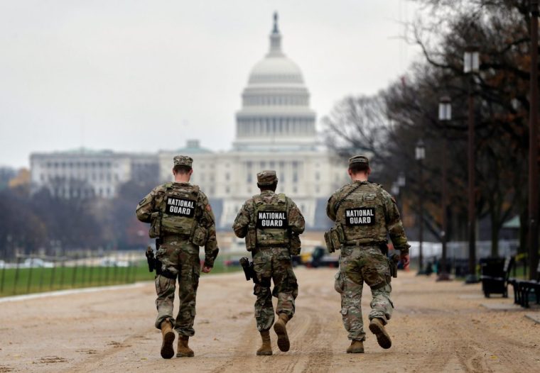 National Guard patrol along the National Mall in front of the Capitol, Wednesday, Nov. 26, 2025, in Washington. (AP Photo/Rahmat Gul)