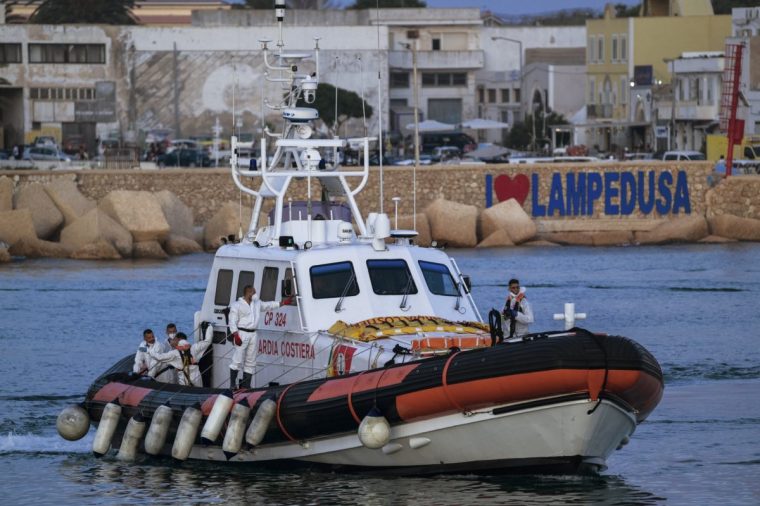 LAMPEDUSA, ITALY - AUGUST 14: Members of the Italian Coast Guard seen on a patrol vessel getting back in the harbor after boats capsized off in Lampedusa, Italy on August 14, 2025. According to Italian authorities at least 27 people, including a 1-year-old girl and three teenagers, died and dozens remain missing after two migrant boats capsized off the Italian island of Lampedusa. The vessels had departed the previous night from Tripoli, Libya, with migrants from Pakistan, Somalia, and Sudan on board. The Italian Coast Guard said 60 survivors were rescued and brought ashore to the Imbriacola reception center on Lampedusa. Most were in stable condition, though four were hospitalized for minor fractures. (Photo by Valeria Ferraro/Anadolu via Getty Images)