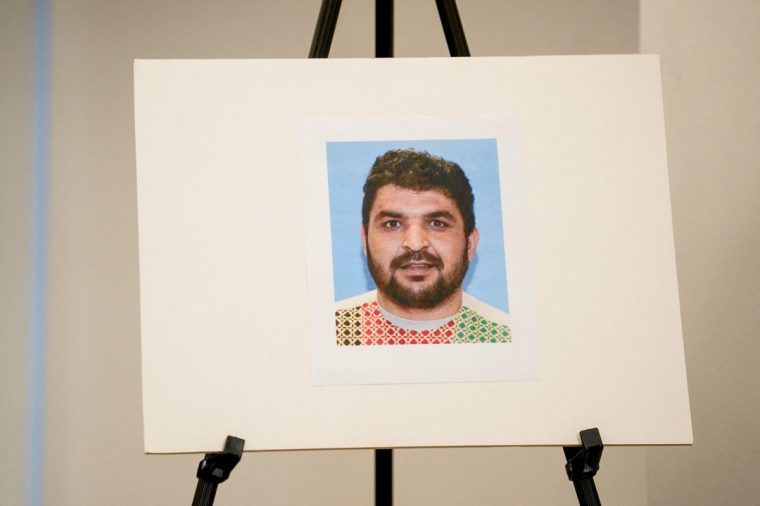 A picture of Rahmanullah Lakanwal, an Afghan national who is the suspect in the shooting of two National Guard members, is displayed at a press conference with FBI Director Kash Patel, attorney Jeanine Pirro and other authorities, in Washington, D.C., U.S., November 27, 2025. REUTERS/Nathan Howard