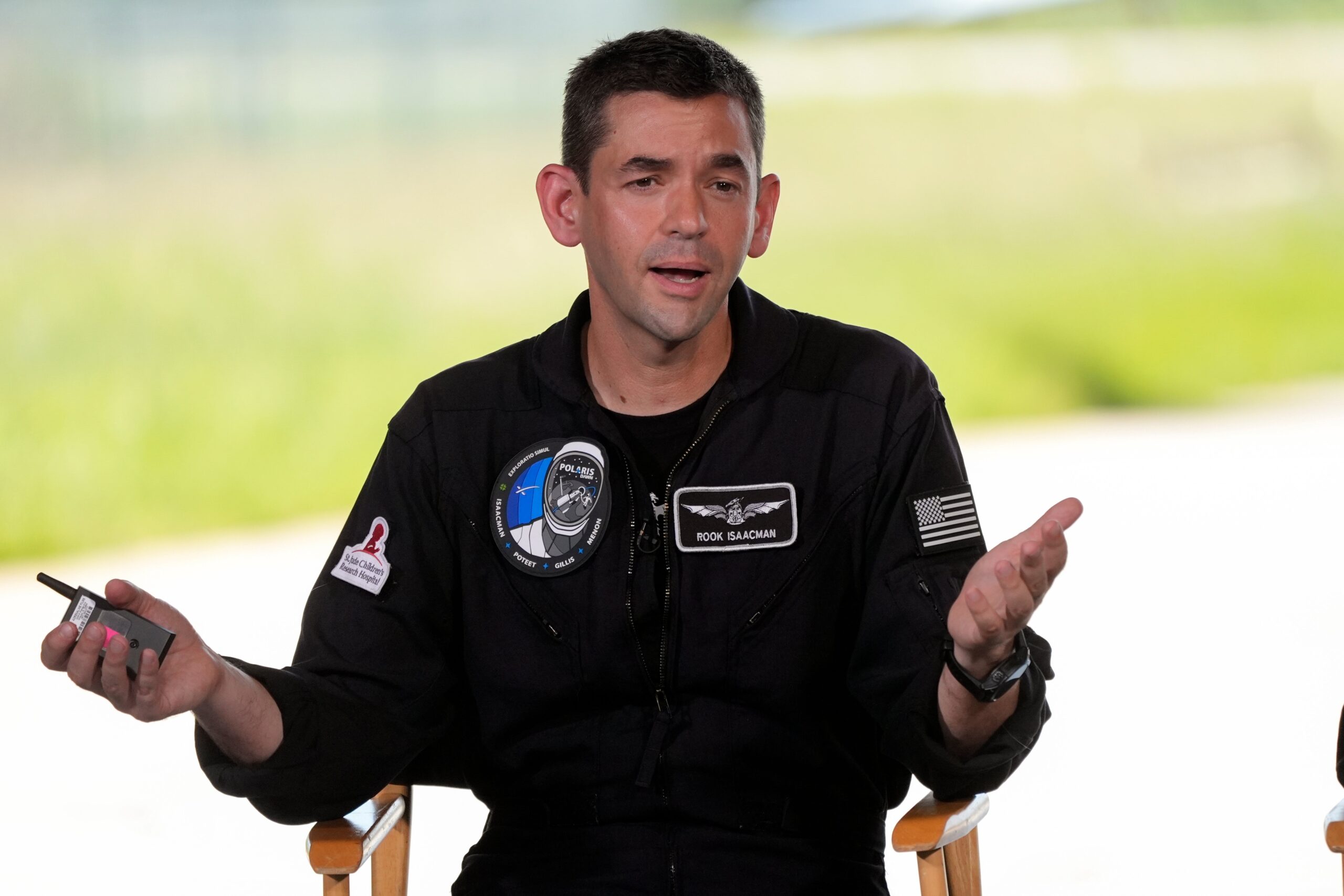 Commander Jared Isaacman speaks at a news conference after arriving at the Kennedy Space Center for an upcoming private human spaceflight mission in Cape Canaveral, Fla., Aug. 19, 2024