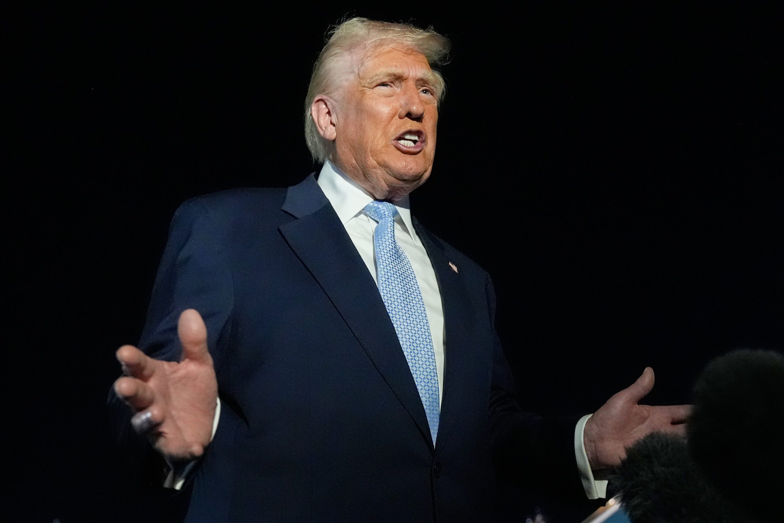 Donald Trump speaks to reporters before boarding Air Force One at Palm Beach International Airport in West Palm Beach