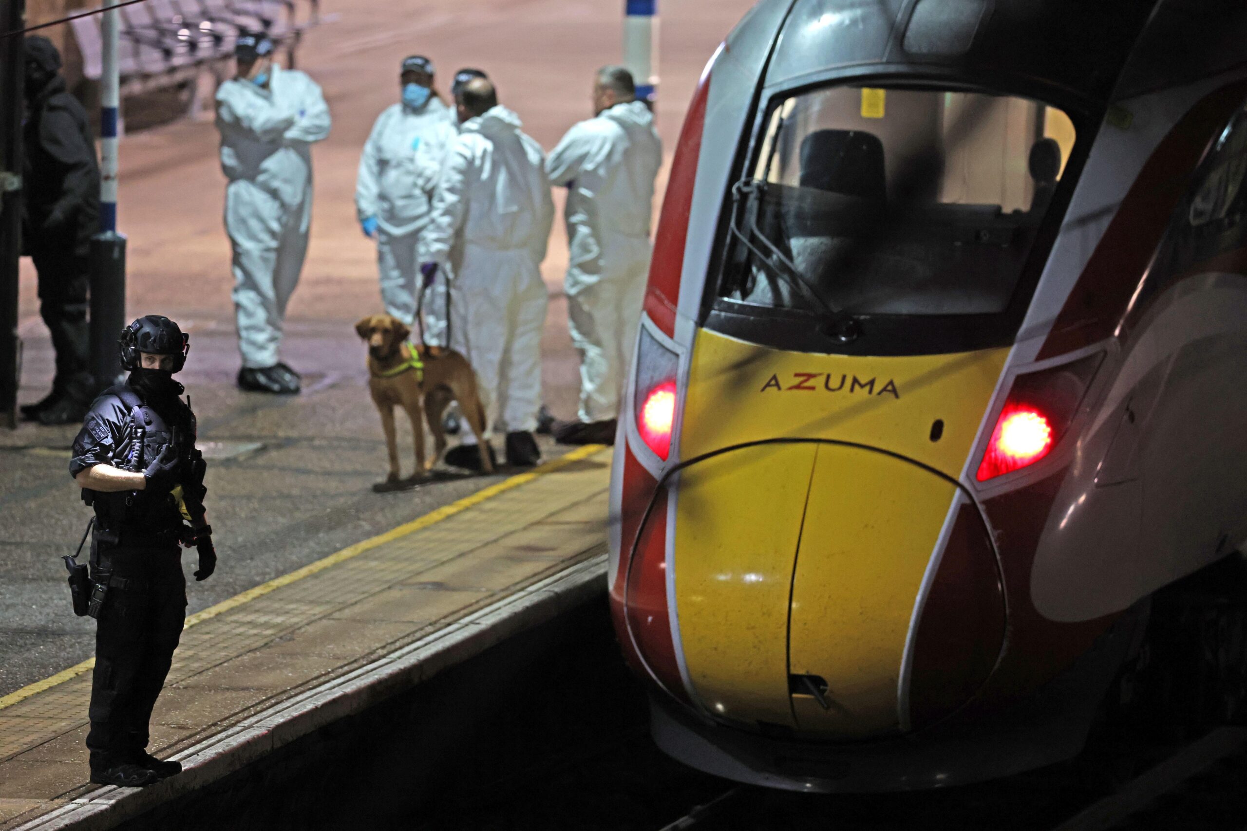 Police examining the train at Huntingdon station in Cambridgeshire after a mass stabbing (Chris Radburn/PA)