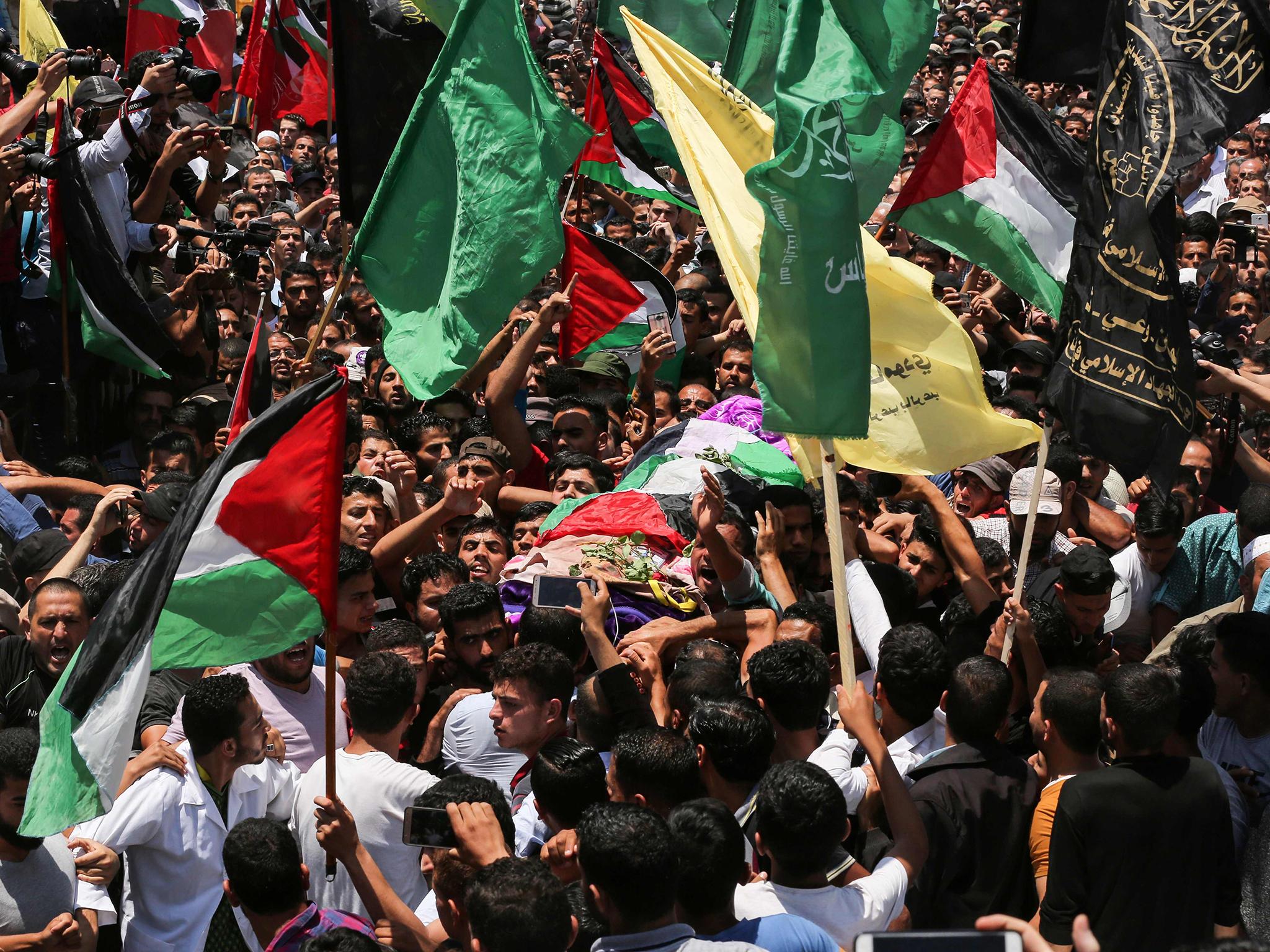 Thousands gathered for the funeral of 21-year-old Razan Najjar, shot dead near the Israel-Gaza border on Friday while rushing to treat a wounded man