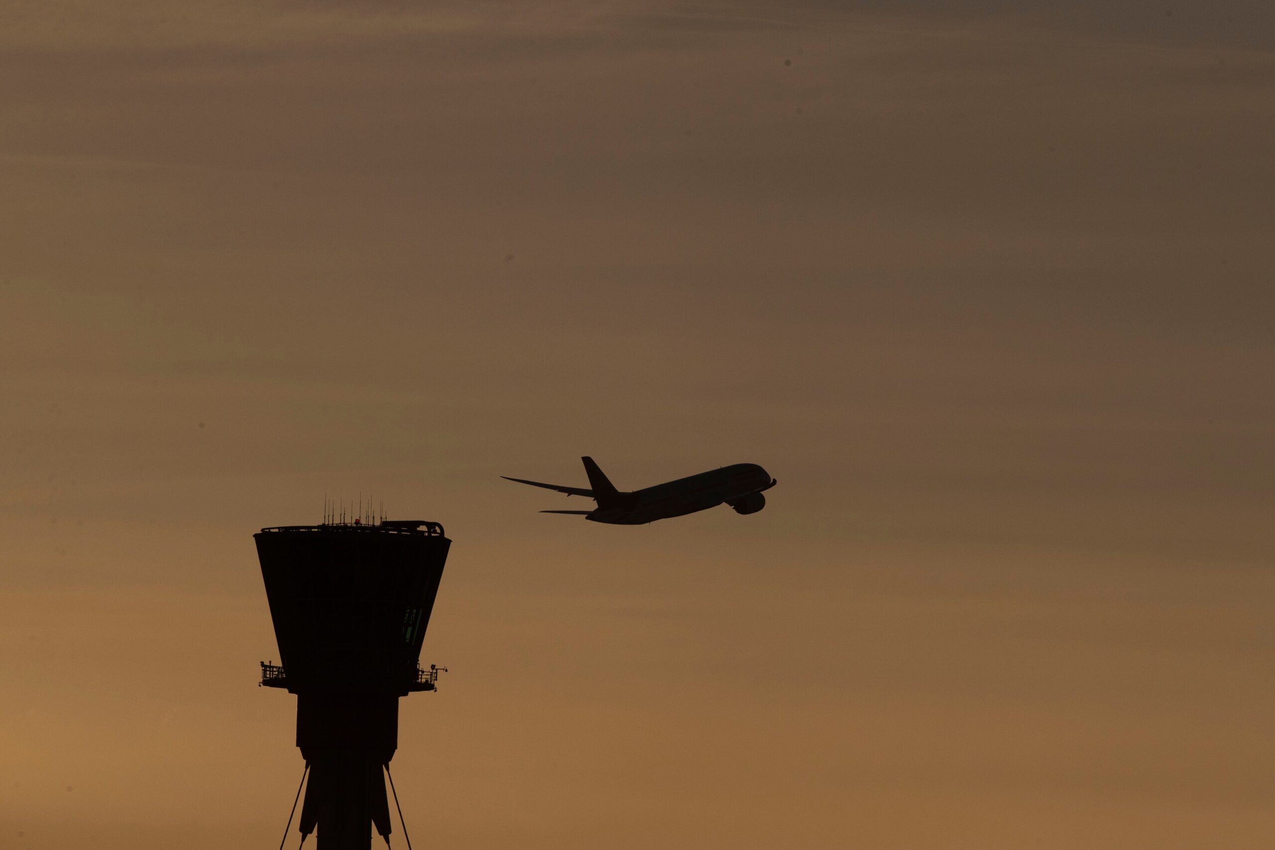 A plane takes off past the control tower at Heathrow Airport, west London (Steve Parsons/PA)