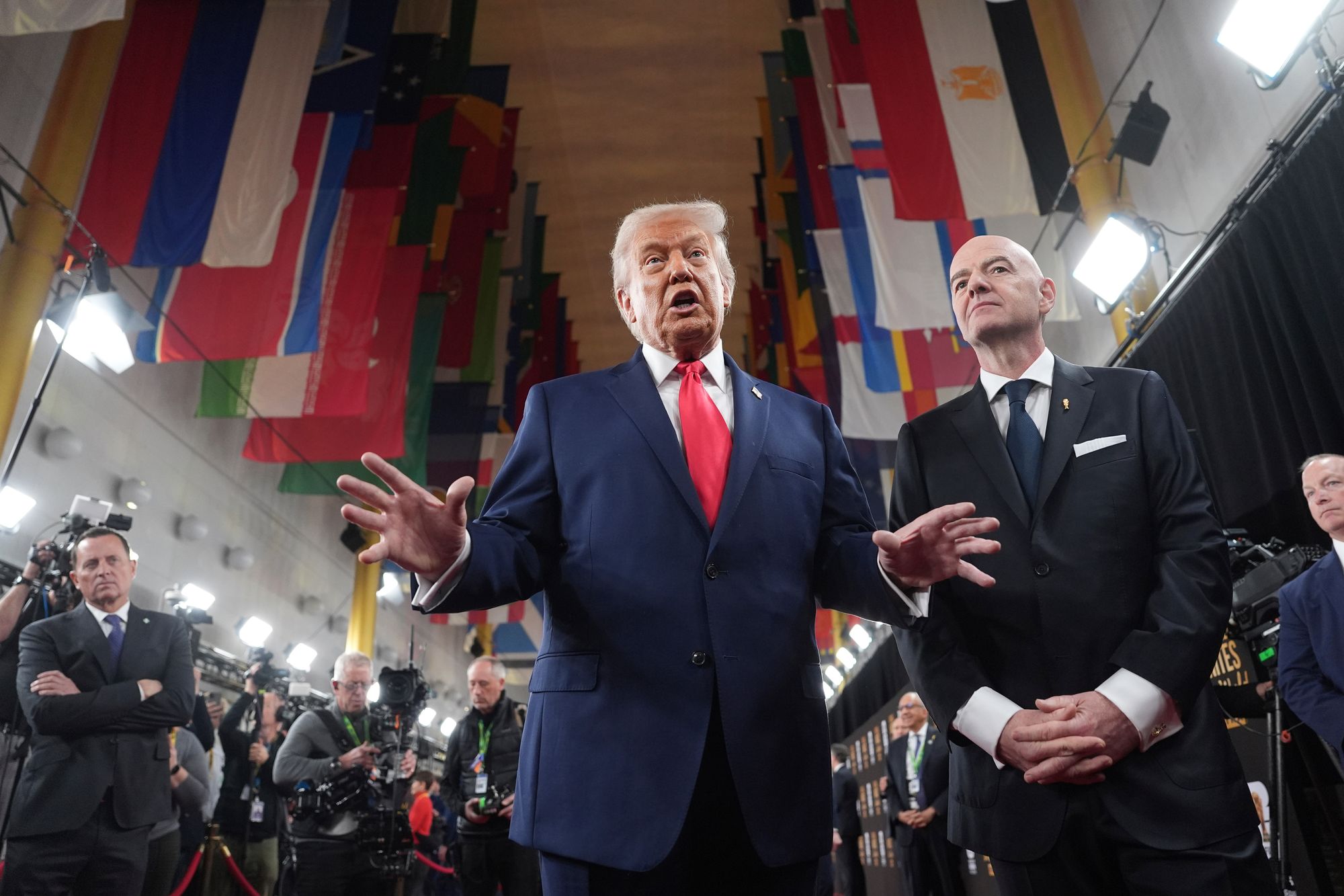 President Donald Trump, center, speaking to members of the media during his arrival with FIFA President Gianni Infantino, right, at the Kennedy Center for the 2026 FIFA World Cup draw, Friday, Dec. 5, 2025, in Washington