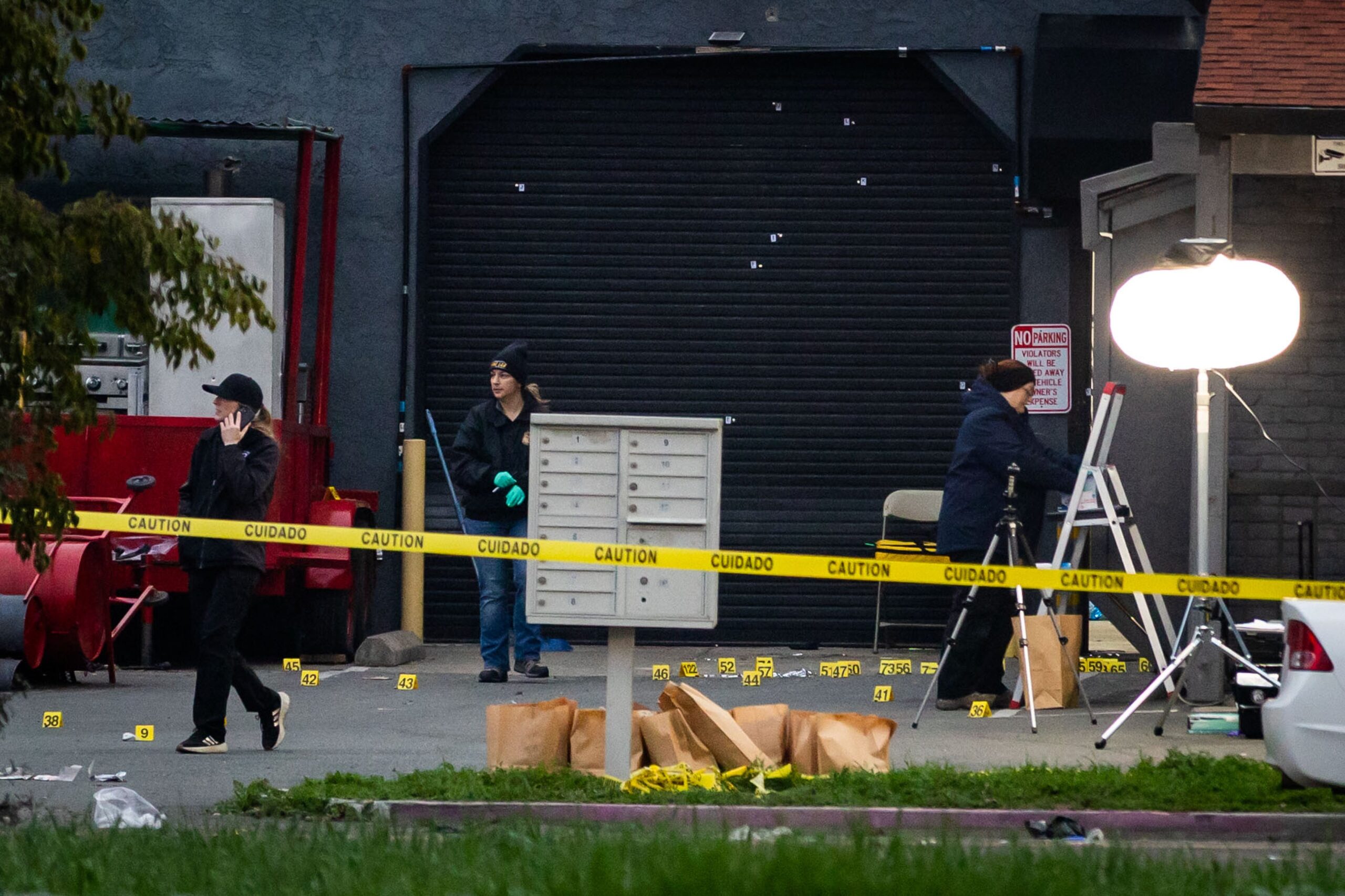Investigators examine the scene of a mass shooting Sunday