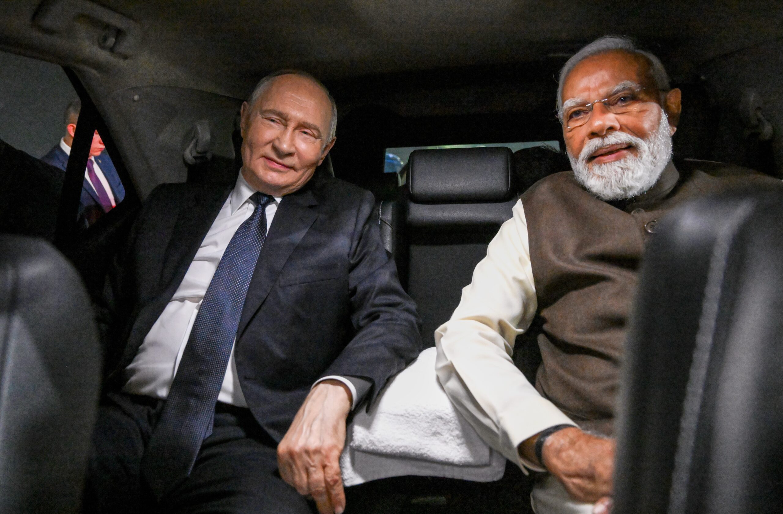 Russian president Vladimir Putin and Indian prime minister Narendra Modi sit inside a limousine after arriving at the Palam Air Base in New Delhi