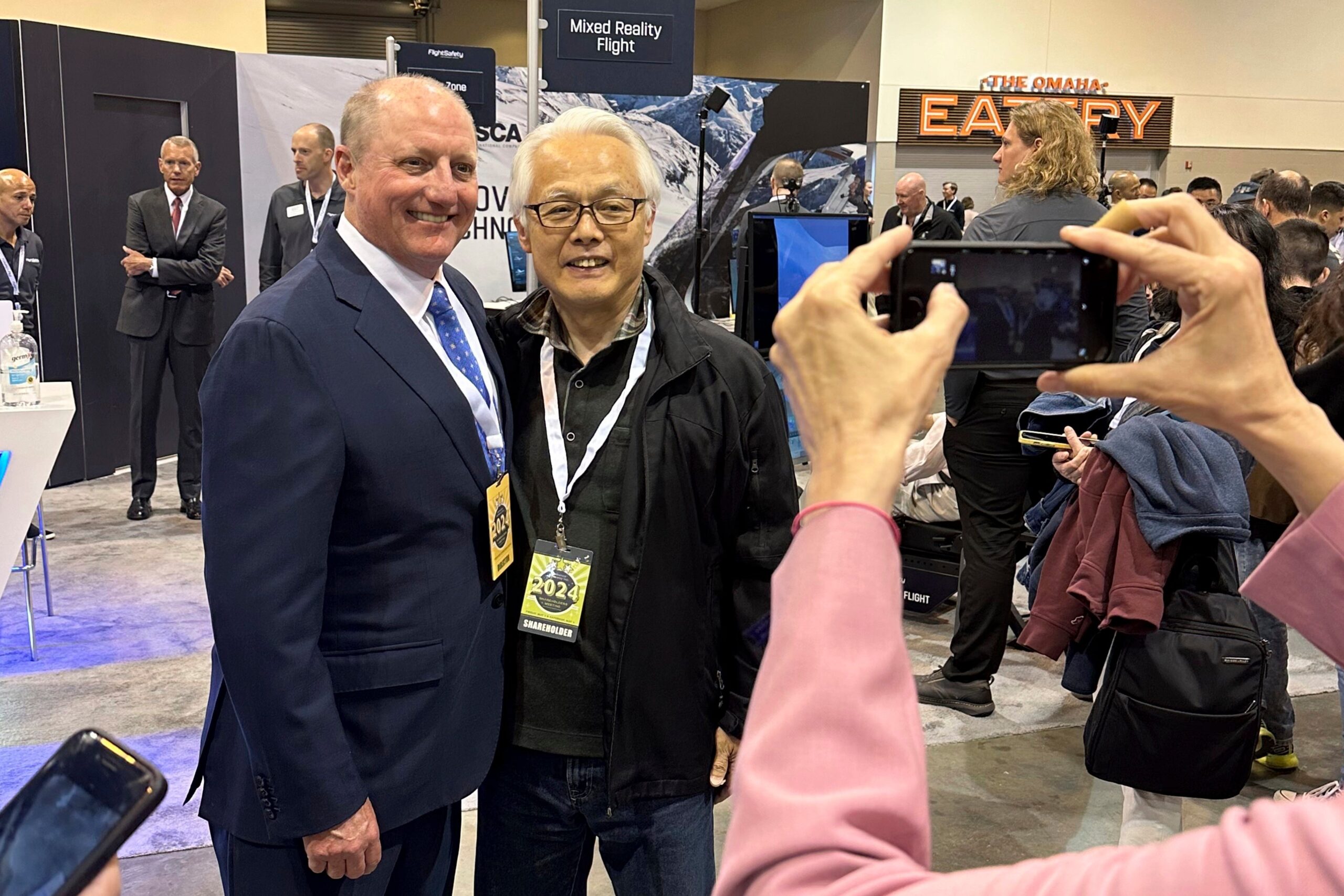Berkshire Hathaway’s new CEO Greg Abel poses for pictures with shareholders
