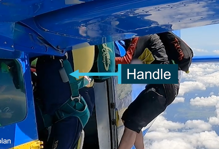 Screengrab shows the grey handle of the chute which accidentally hit the plane and activated the parachute